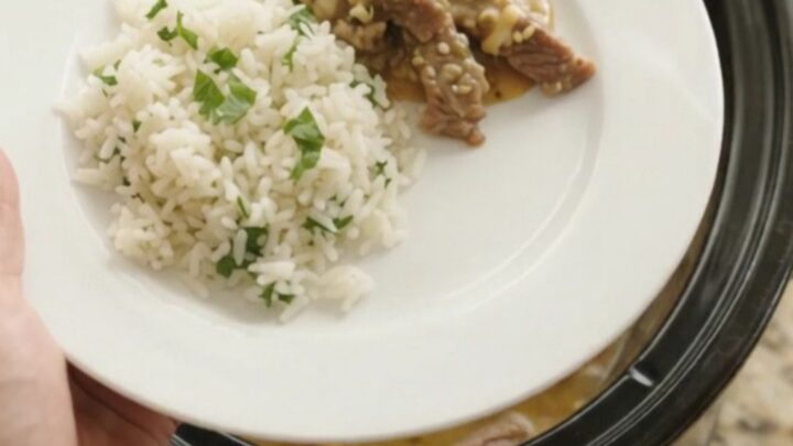 Crockpot with bubbling cheddar salsa verde sauce and tender skirt steak strips