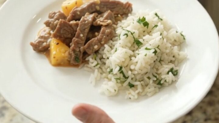 Slow cooker filled with creamy cheddar chipotle pineapple skirt steak, bubbling and steaming
