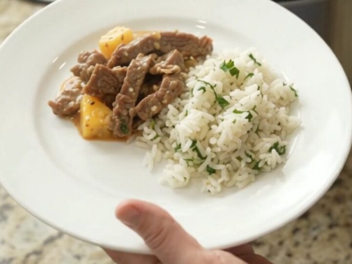 Slow cooker filled with creamy cheddar chipotle pineapple skirt steak, bubbling and steaming