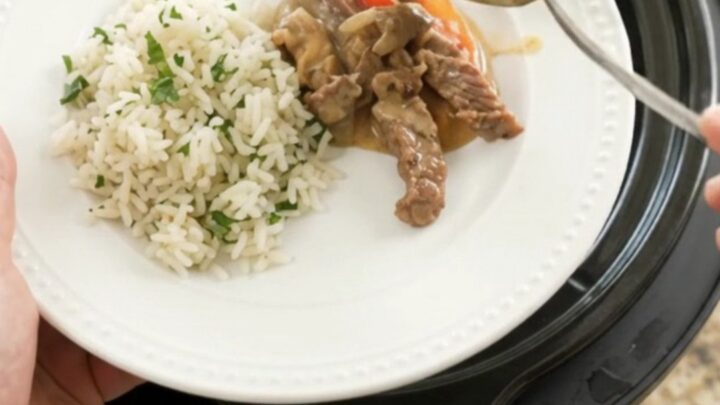 Slow cooker cheddar fajita skirt steak with peppers and onions in creamy cheese sauce