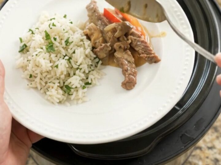 Slow cooker cheddar fajita skirt steak with peppers and onions in creamy cheese sauce