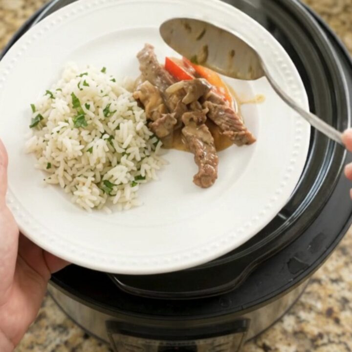 Slow cooker cheddar fajita skirt steak with peppers and onions in creamy cheese sauce