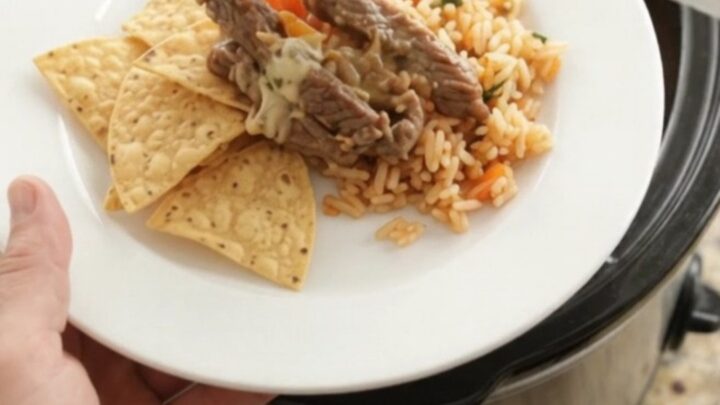 Slow-cooker pepper jack fajita skirt steak with melted cheese and peppers in a crockpot