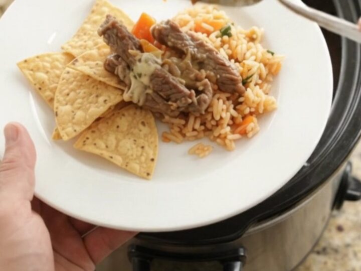 Slow-cooker pepper jack fajita skirt steak with melted cheese and peppers in a crockpot