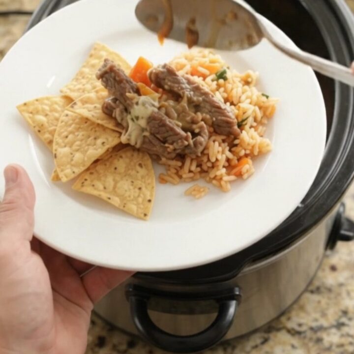 Slow-cooker pepper jack fajita skirt steak with melted cheese and peppers in a crockpot