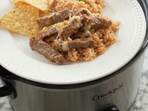 Slow cooker with tender skirt steak in creamy chipotle pineapple queso sauce