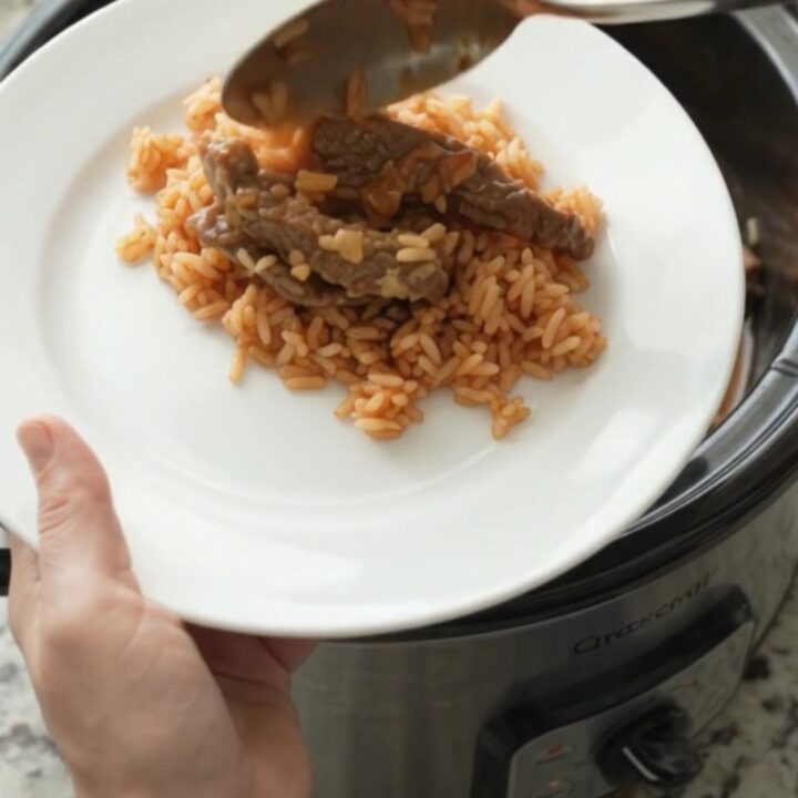 A slow cooker filled with tender skirt steak, roasted poblanos, and hominy in a melted Oaxaca cheese sauce.