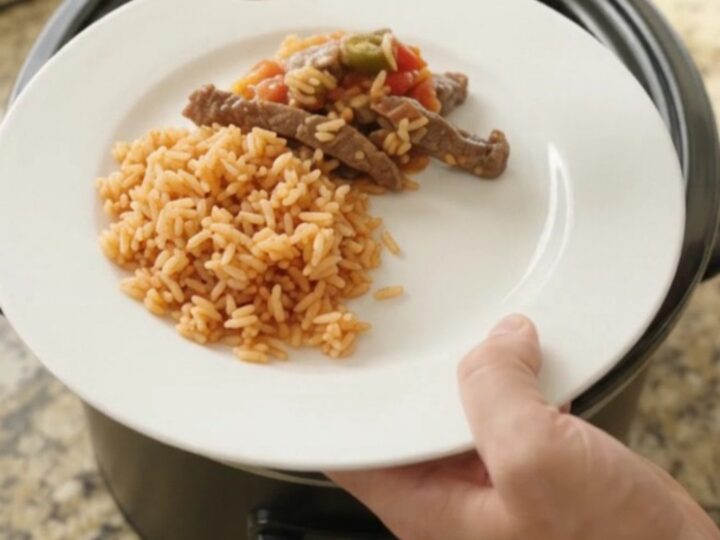 Slow cooker with bubbling cheese and steak strips