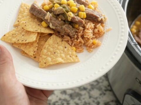 Slow cooker filled with tender skirt steak strips in a creamy pepper jack sauce with green chiles and corn.