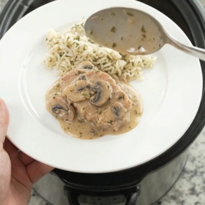 Creamy slow-cooker pork chops with mushroom-ranch sauce in a black Crockpot