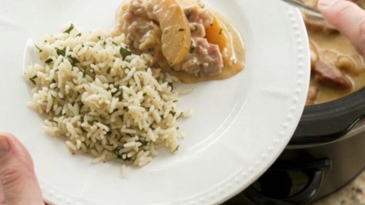 Crockpot with bubbling Parmesan apple cider pork chops and apples