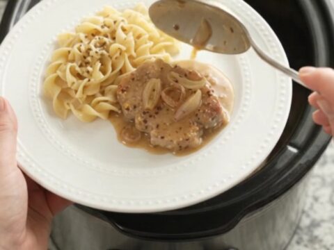 Crockpot Sour Cream Honey Dijon Pork Chops in a slow cooker with creamy sauce