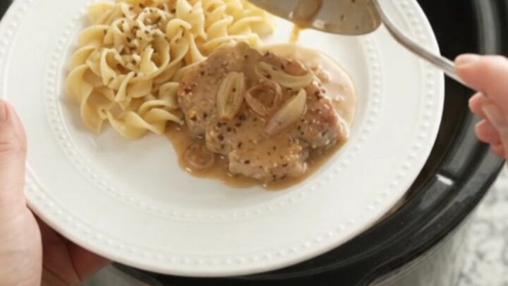 Crockpot Sour Cream Honey Dijon Pork Chops in a slow cooker with creamy sauce