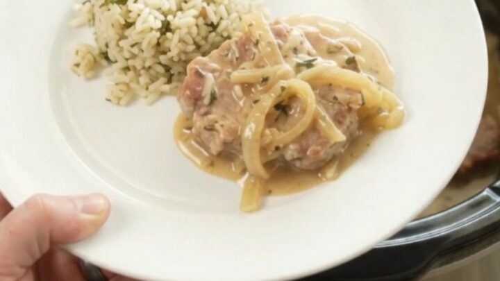 Crockpot Parmesan French Onion Pork Chops with creamy sauce and caramelized onions