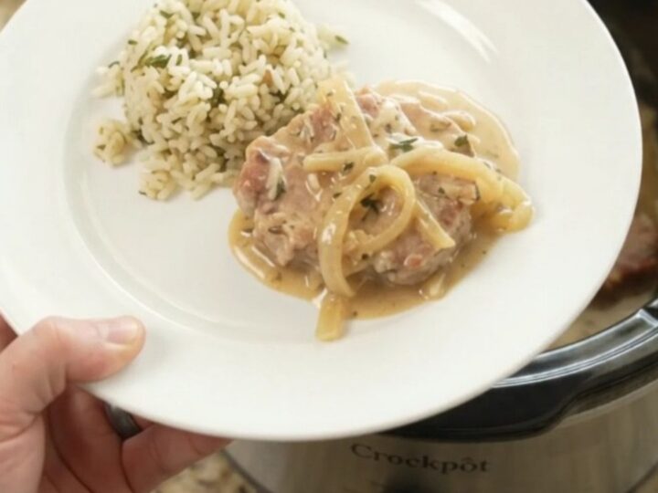 Crockpot Parmesan French Onion Pork Chops with creamy sauce and caramelized onions