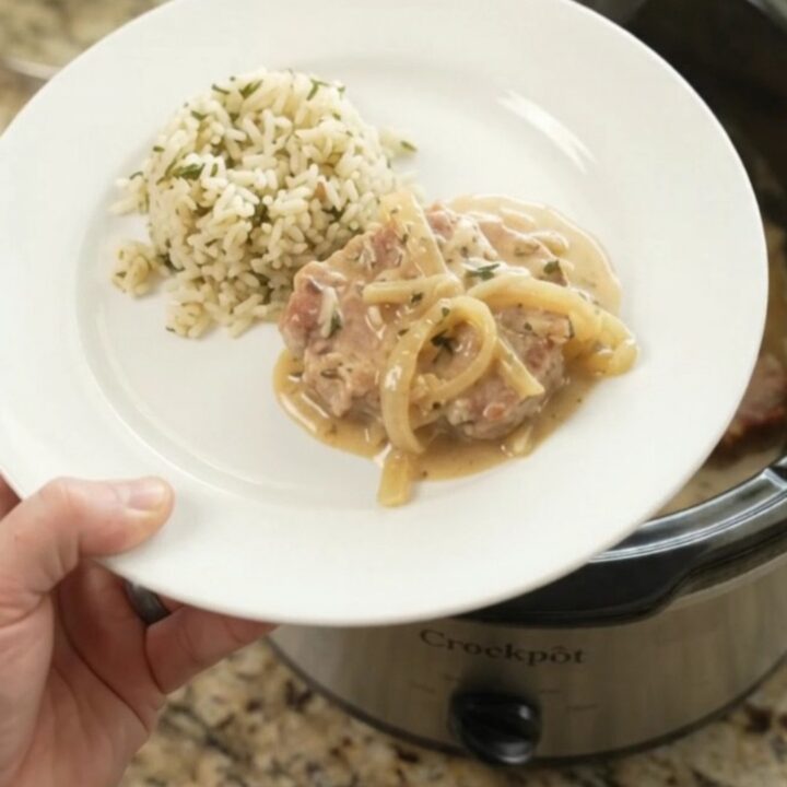 Crockpot Parmesan French Onion Pork Chops with creamy sauce and caramelized onions