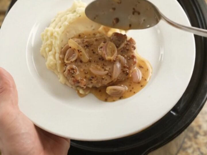 Slow-cooked pork chops in a creamy honey-Dijon sauce with melted Gruyère in a crockpot