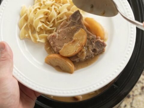 Bone-in pork chops and apples in a creamy sour cream sauce in a slow cooker