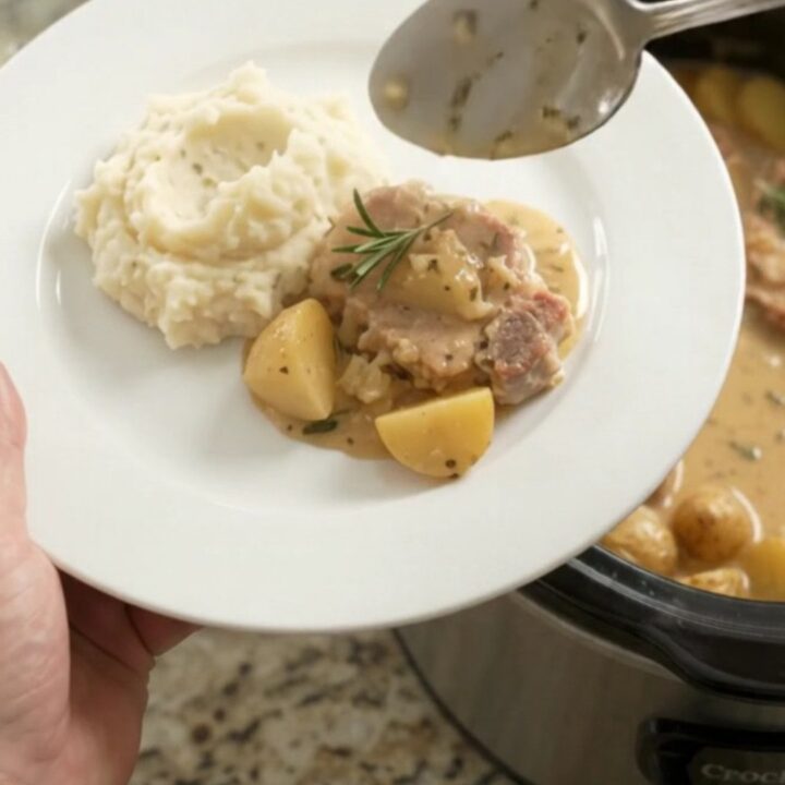 Slow cooker butter cream garlic herb pork chops with potatoes in creamy sauce