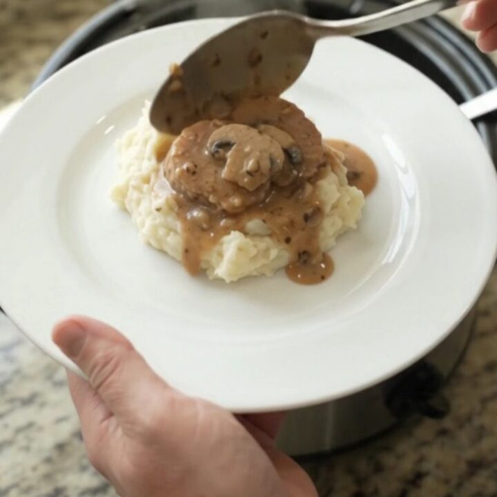 Pork tenderloin medallions in creamy mushroom-ranch sauce in a slow cooker.