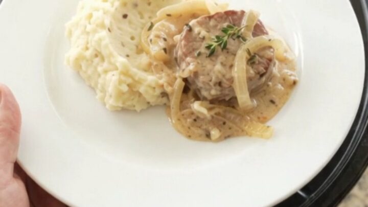 Pork medallions in a creamy Gruyère sauce with onions, served in a slow cooker.