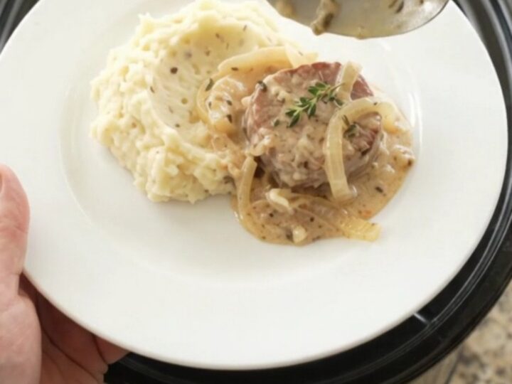 Pork medallions in a creamy Gruyère sauce with onions, served in a slow cooker.