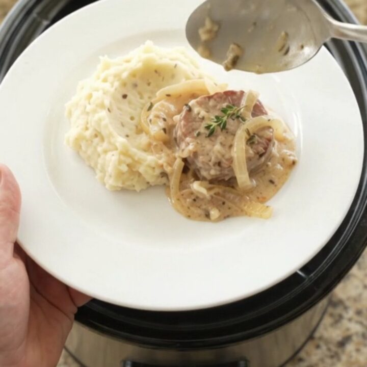 Pork medallions in a creamy Gruyère sauce with onions, served in a slow cooker.