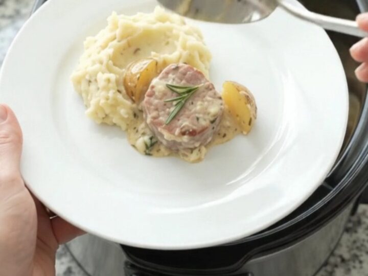 Slow cooker with pork medallions and baby potatoes in creamy Gruyère sauce