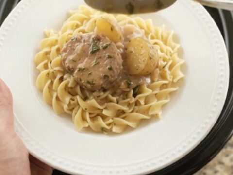 Slow cooker pork medallions and baby potatoes in creamy sour cream gravy with garlic and rosemary