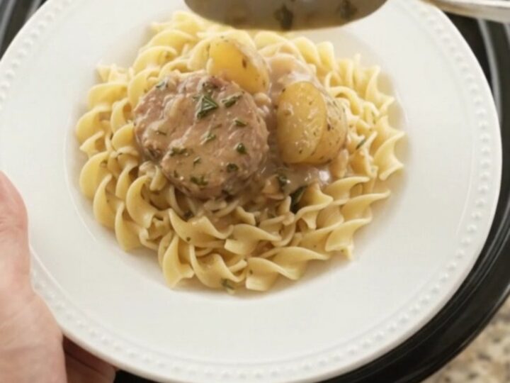 Slow cooker pork medallions and baby potatoes in creamy sour cream gravy with garlic and rosemary