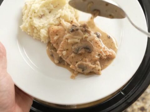 Slow cooker turkey cutlets in creamy mushroom-ranch gravy with melted Gruyère cheese
