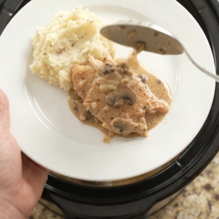 Slow cooker turkey cutlets in creamy mushroom-ranch gravy with melted Gruyère cheese
