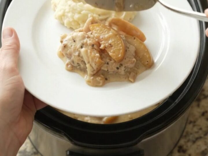 Tender turkey cutlets in a creamy Gruyère sauce with caramelized apples, served from a slow cooker.