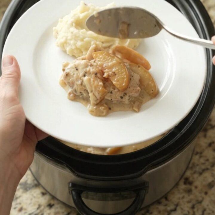 Tender turkey cutlets in a creamy Gruyère sauce with caramelized apples, served from a slow cooker.