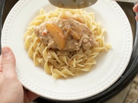 Slow cooker turkey cutlets with apples and creamy gravy in a black crockpot