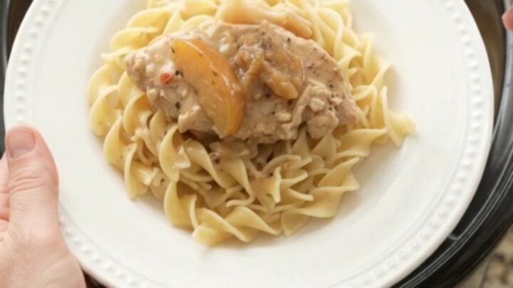 Slow cooker turkey cutlets with apples and creamy gravy in a black crockpot