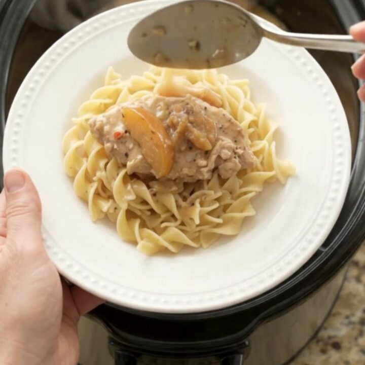 Slow cooker turkey cutlets with apples and creamy gravy in a black crockpot