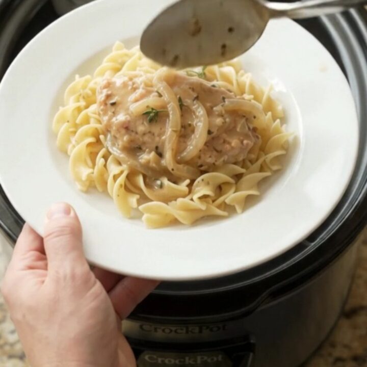 Smothered turkey cutlets in creamy sour cream French onion gravy in a slow cooker