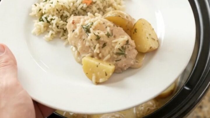 Slow cooker with creamy Parmesan turkey cutlets and baby potatoes, topped with fresh rosemary