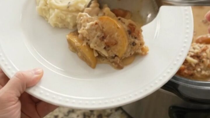 Slow cooker chicken cutlets with apples and Gruyère cream sauce, bubbling in the crockpot