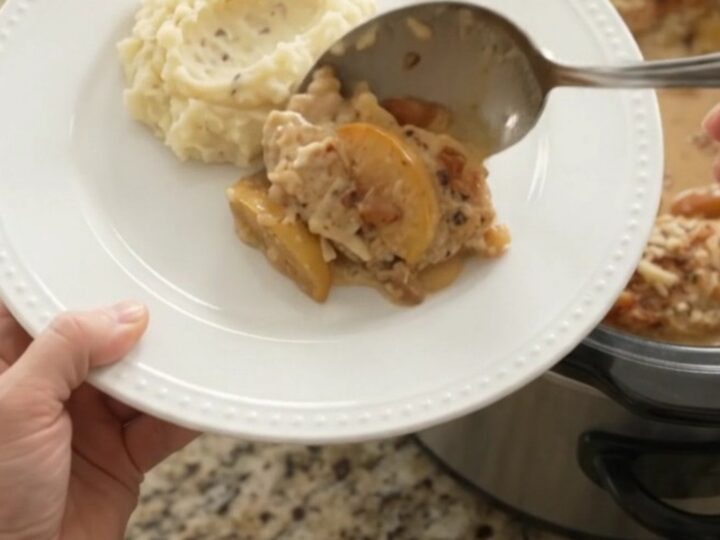 Slow cooker chicken cutlets with apples and Gruyère cream sauce, bubbling in the crockpot