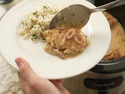 Creamy Parmesan honey Dijon chicken cutlets in a slow cooker with a velvety sauce and shallots.