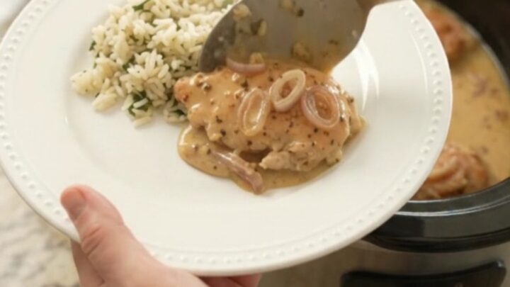 Creamy Parmesan honey Dijon chicken cutlets in a slow cooker with a velvety sauce and shallots.