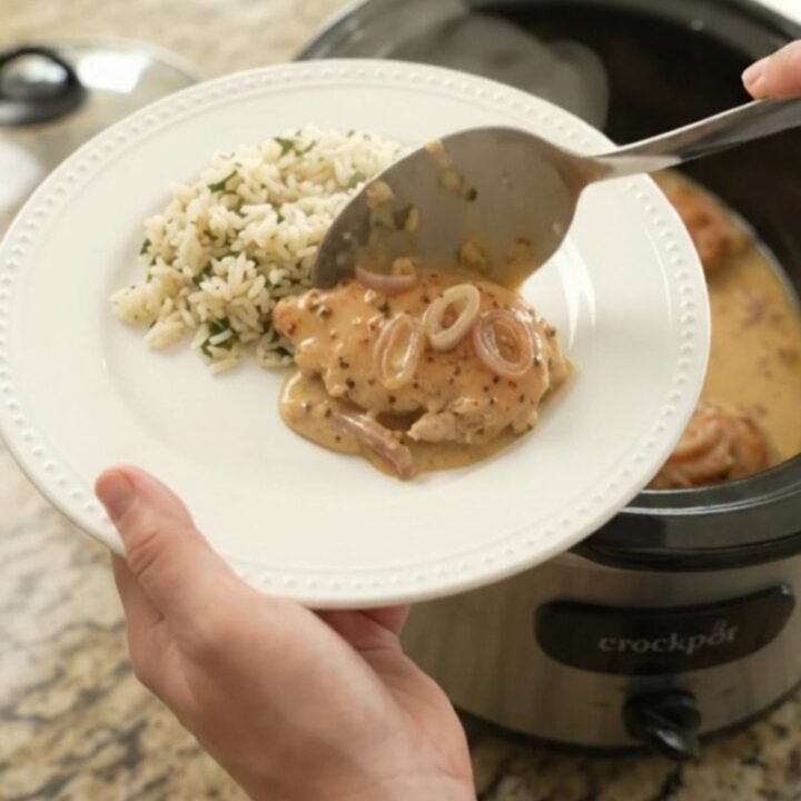 Creamy Parmesan honey Dijon chicken cutlets in a slow cooker with a velvety sauce and shallots.