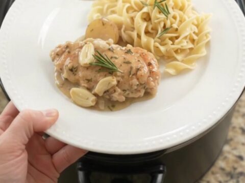 Slow cooker sour cream garlic herb chicken cutlets with baby potatoes in a creamy pan gravy.