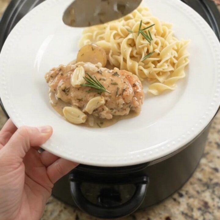 Slow cooker sour cream garlic herb chicken cutlets with baby potatoes in a creamy pan gravy.