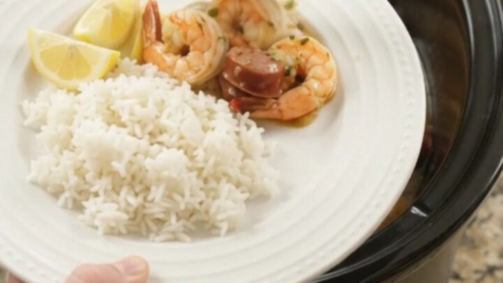 Slow cooker filled with chili lime butter shrimp, sausage, and potatoes