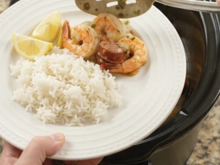 Slow cooker filled with chili lime butter shrimp, sausage, and potatoes