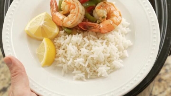 Slow cooker chili lime butter jumbo shrimp with bell peppers and onions in a glossy butter sauce.