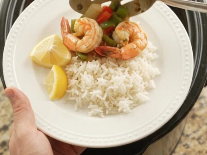 Slow cooker chili lime butter jumbo shrimp with bell peppers and onions in a glossy butter sauce.